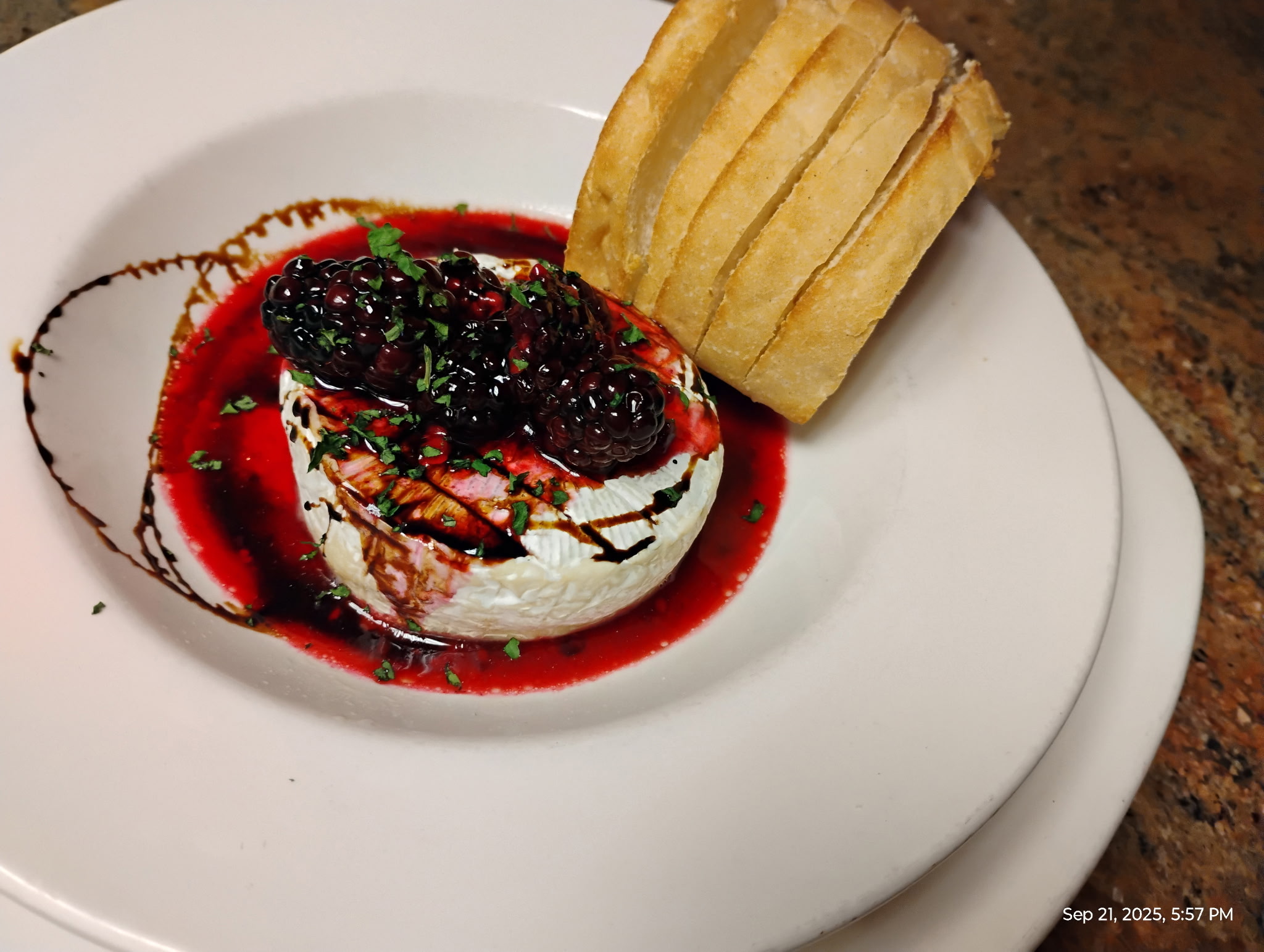 Warm baked brie topped with a choice of fruit coulis & balsamic reduction (shown above), honey with pecans, or roasted garlic cream sauce. Served with toasted french bread.